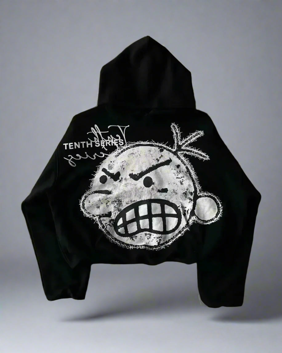 Black hoodie with a graphic design on the back against a gray background