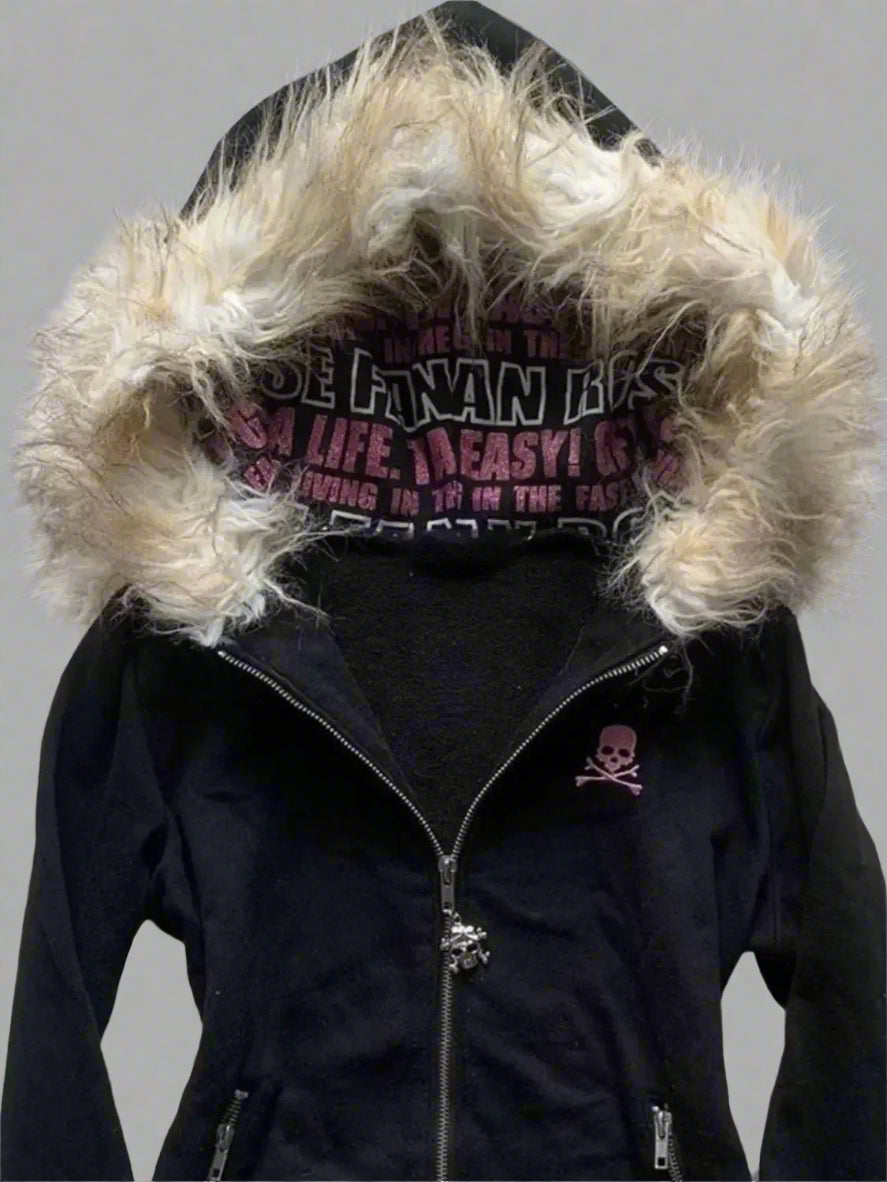 Black jacket with fur-lined hood on a textured surface