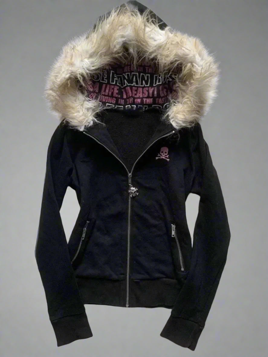Black jacket with fur-lined hood on a textured gray surface