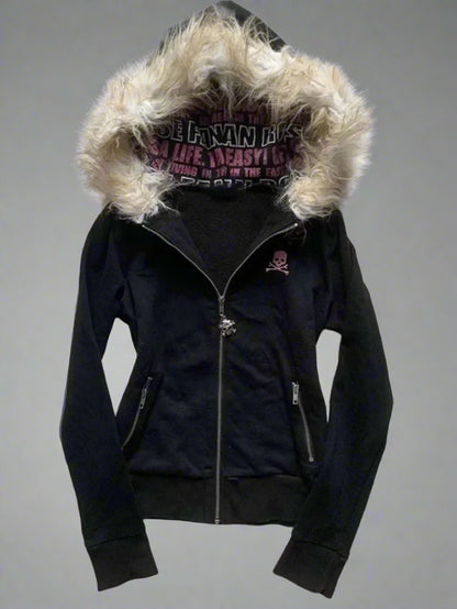 Black jacket with fur-lined hood on a textured gray surface