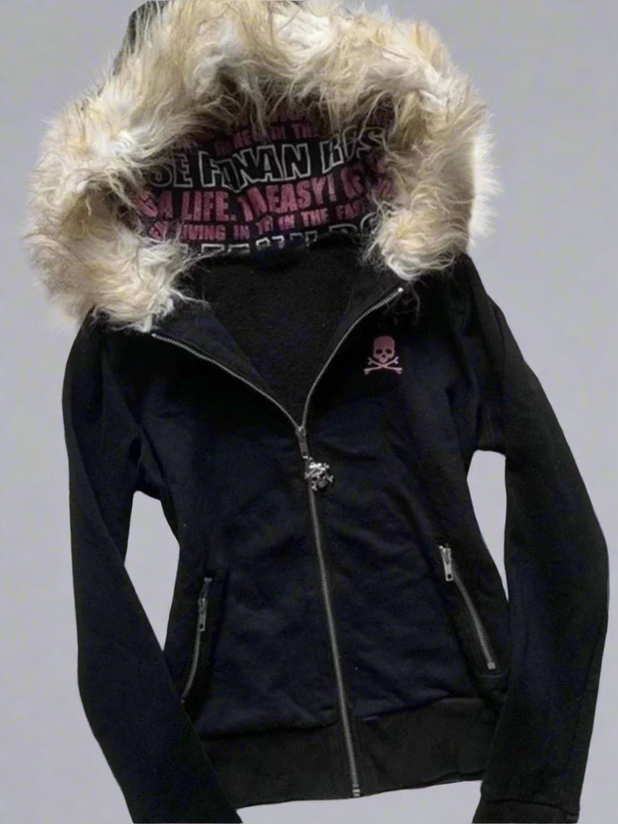 Black jacket with fur-lined hood on a textured surface